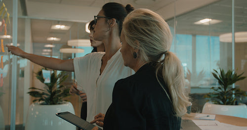 Business team discussing over sticky notes 