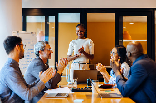 Confident professional leading a discussion in a team meeting setting