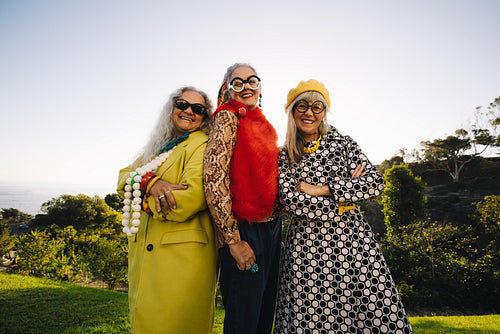 Mature eccentric women smiling happily while standing in a park