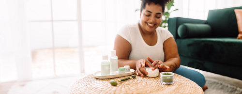 Woman using cream for skin care