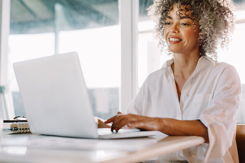 Happy businesswoman working from home during lockdown