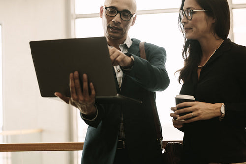 Business team working together on laptop in office