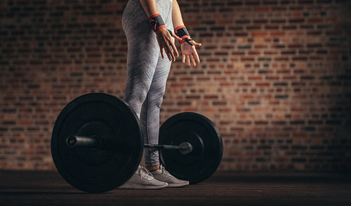 Woman doing weight lifting workout at gym