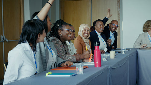 Diverse group of business professionals actively participates in a workshop