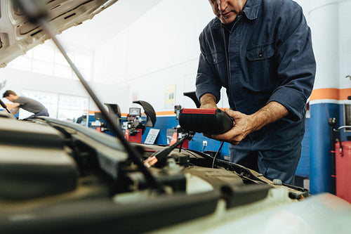 Technician using electronic equipment to diagnose the car
