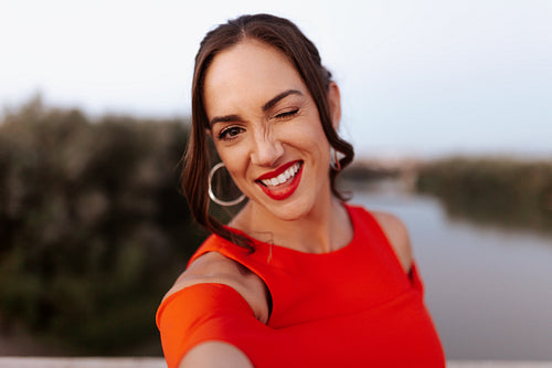 Woman taking a selfie while standing on a bridge