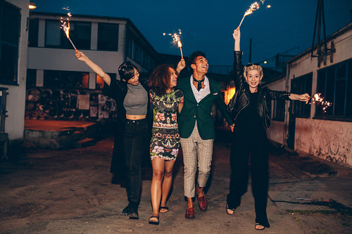 Friends enjoying night with sparklers