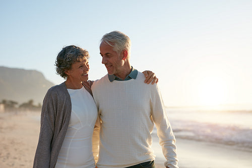 Loving senior couple having a walk on the beach