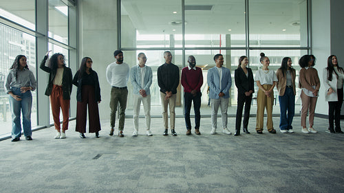 Happy business team stands together