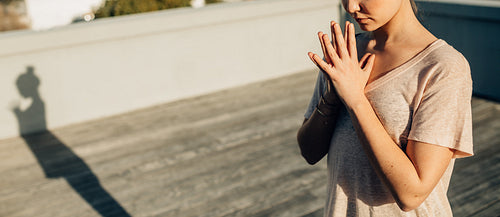Woman doing yoga on her terrace at home