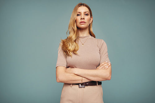 Empowered woman standing alone in a studio