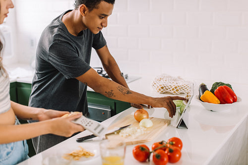 Cooking couple taking an online cooking class