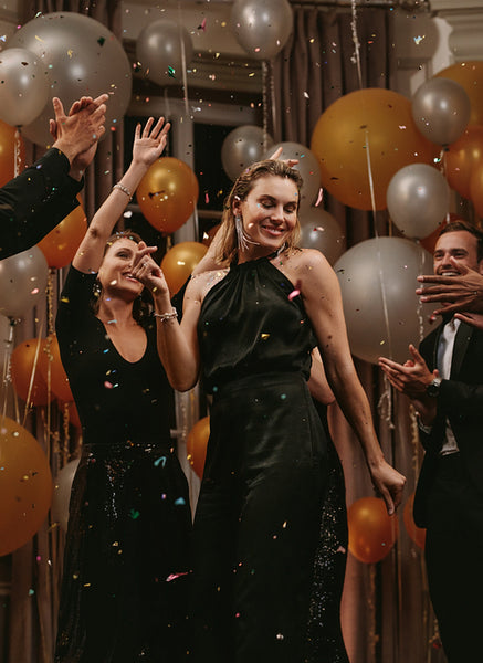 Woman dancing at gala night with friends