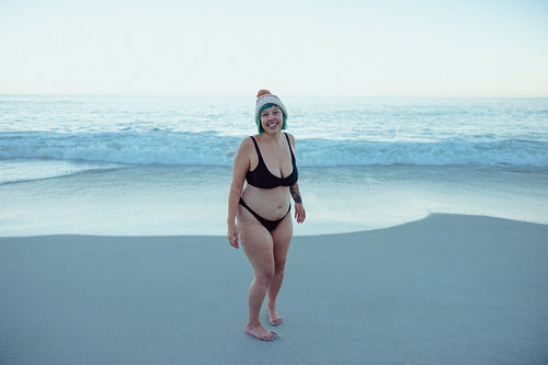 Carefree winter bather smiling at the camera at the beach