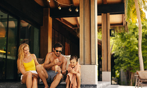 Happy family enjoying ice cream at a tropical island resort