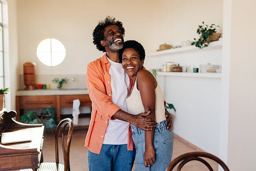 Loving Brazilian husband hugging his wife, smiling and spending time at home with the love of his life