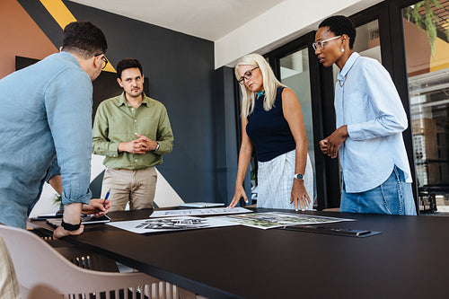 Professional team discussing project ideas in modern workspace with teamwork focus