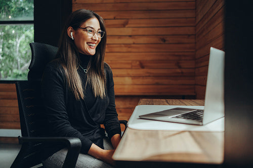 Female entrepreneur having an online meeting in a coworking spac