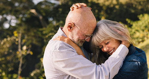 Mature couple touching their heads together outdoors