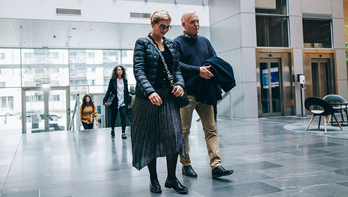 Senior business professionals arriving to office