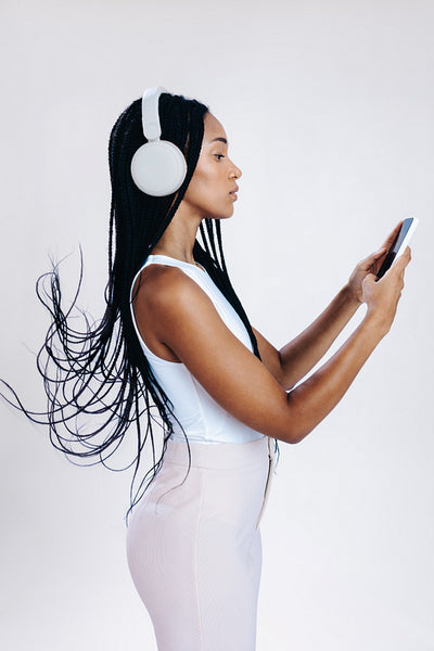 Sideview of a young woman choosing an audio playlist on her phone