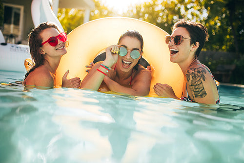 Women friends enjoying together in pool 
