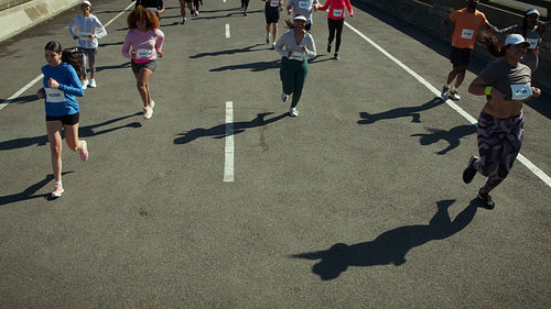 Marathon runners celebrating on highway
