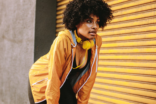 Sportswoman taking rest while training outdoors