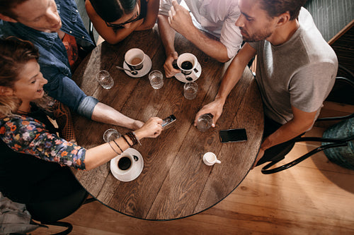 Young people looking at pictures on smart phone