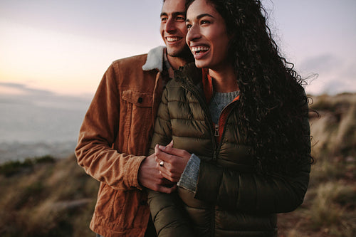 Couple enjoying the view from mountain peak