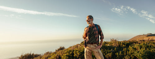 Hiker enjoying the scenic view from a hilltop