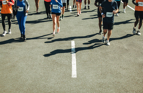 Group of runners participating in a road race on asphalt
