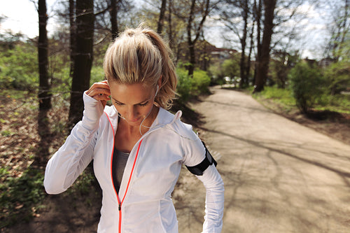 Fit woman athlete before her run in forest
