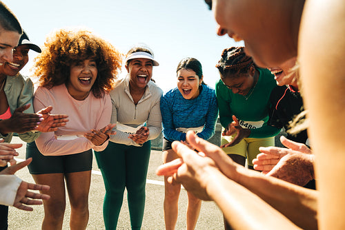 Group of diverse runners cheering and supporting each other