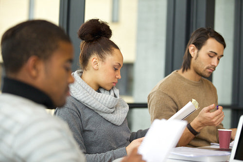 Woman studying hard for exams in library