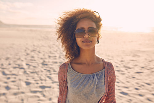 Attractive young woman standing on a beach
