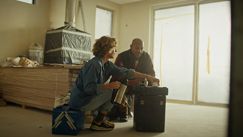Mature couple taking a break during home renovation