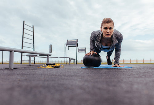 Young and fit sportswoman doing pushups