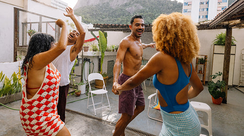 Summer hose party with friends enjoying water, music, and laughter in Rio