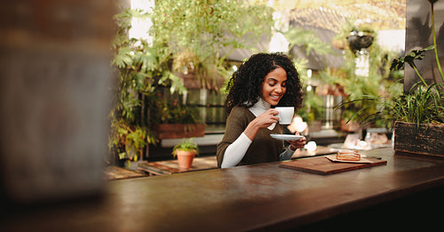 Woman enjoying coffee with breakfast