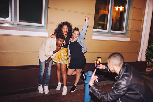 Cheerful friends posing for a group photo outdoors