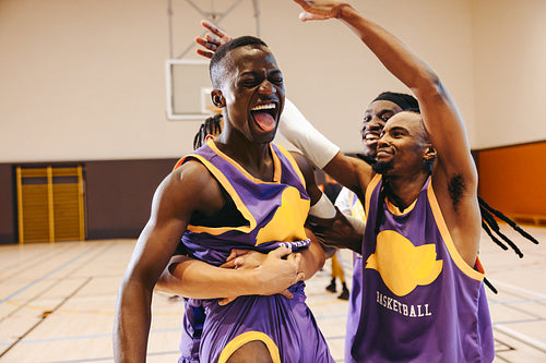Final buzzer joy: Men's basketball team celebrates hard-earned win