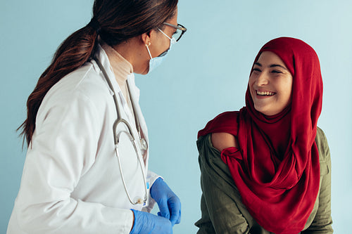 Woman in hijab getting vaccination