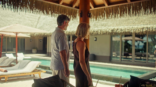 Family arriving to visit grandparents at tropical resort villa