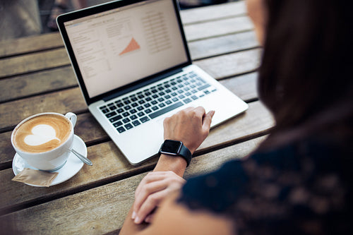 Woman in cafe using latest technology devices