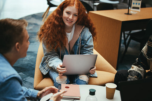 Young student having group study with friend in college