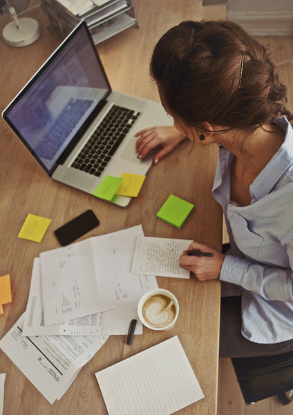 Young brunette using laptop while at work