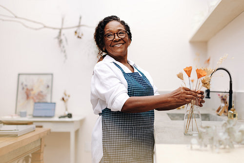 Mature florist running a small business, selling dried floral craft