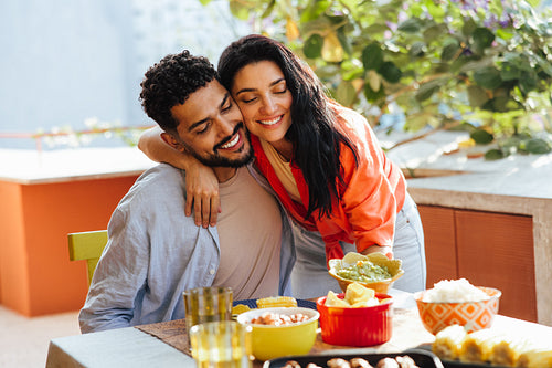 Happy couple enjoying a meal outdoors on a sunny day