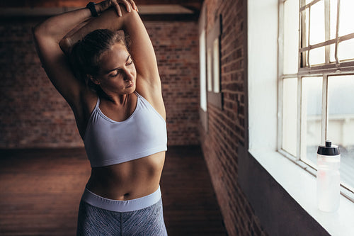 Female warming up for workout at gym